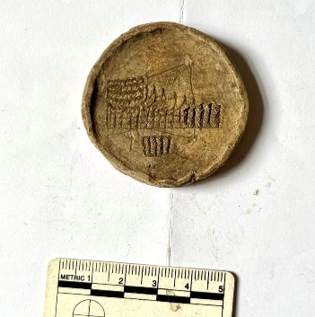 Engraved lead weight showing ship design