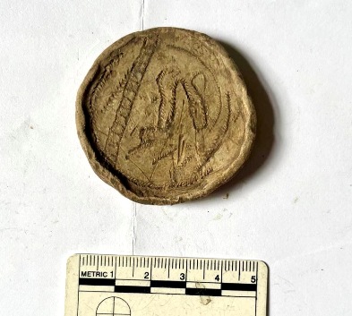 Engraved lead weight showing animal in tree